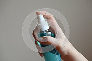 HandÃ¢â¬â¹ holdingÃ¢â¬â¹ theÃ¢â¬â¹ liquidÃ¢â¬â¹ alcoholÃ¢â¬â¹ sprayÃ¢â¬â¹ tube for cleaning and disinfecting the hands. photo
